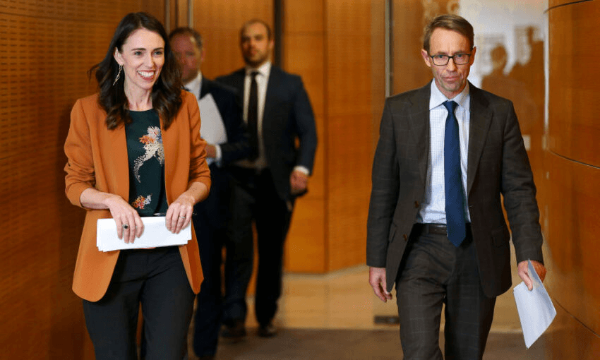 Jacinda Ardern and Ashley Bloomfield arrive at a press conference in June. (Photo by Hagen Hopkins/Getty Images) 
