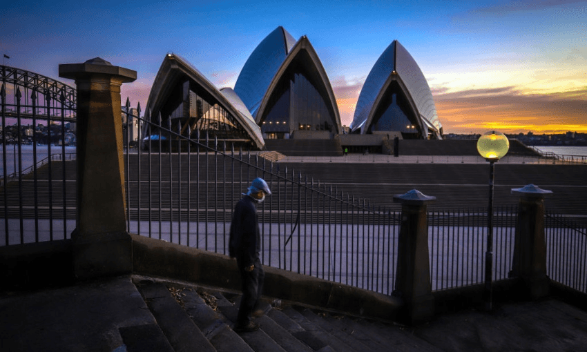 A man wearing a mask in front of the Sydney Opera House (Getty Images) 
