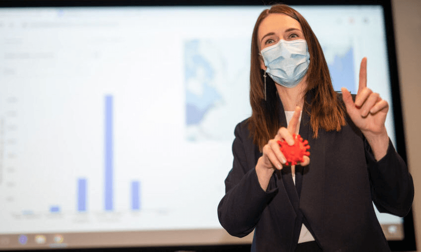 Jacinda Ardern at the Institute of Environmental Science and Research on Friday. Please be assured that is not a real coronavirus in her hand (Photo: Dom Thomas – Pool/Getty Images) 

