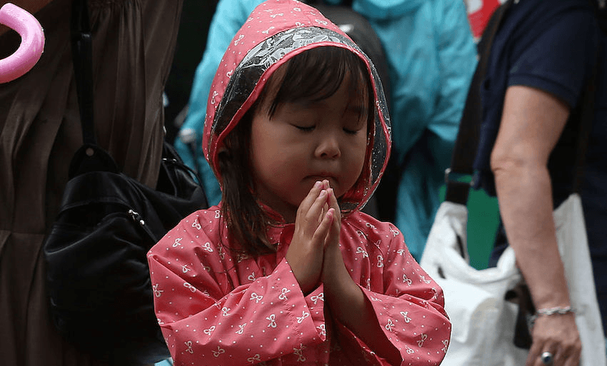 A child prays at the Hiroshima Peace Memorial Park on the 69th anniversary of the atomic bombing of Hiroshima on August 6, 2014 in Hiroshima, Japan. (Photo: Buddhika Weerasinghe/Getty Images) 
