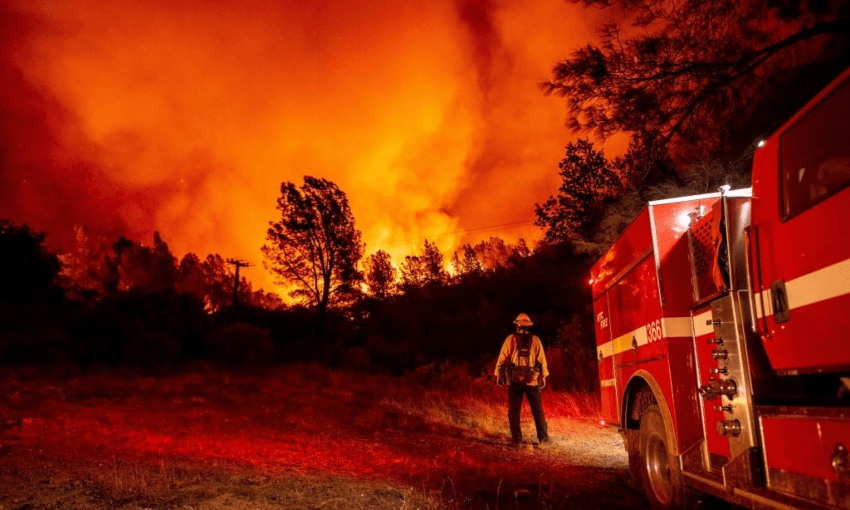A firefighter looks out at the Bear fire near Oroville, California in September 2020 (Getty Images) 

