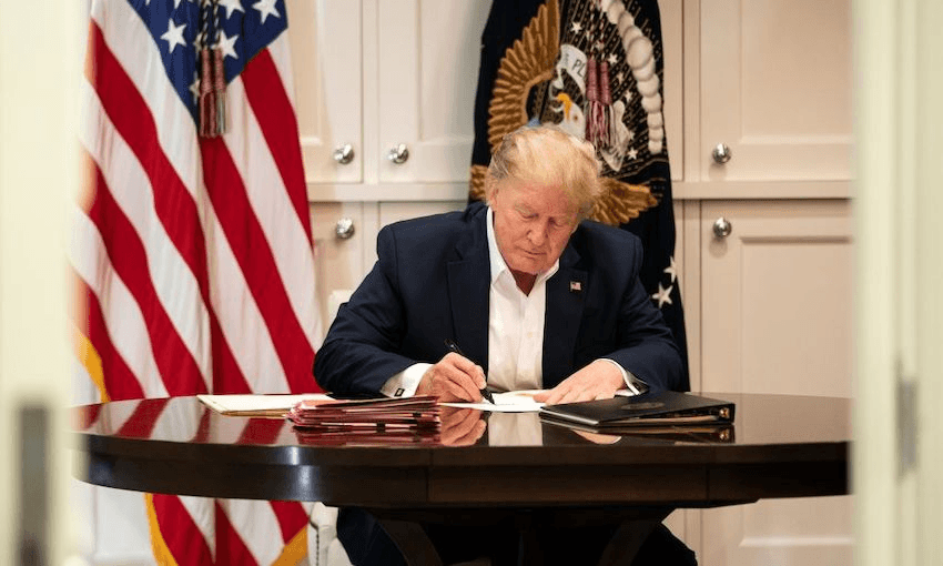 President Donald J. Trump signs documents in the Presidential Suite at Walter Reed National Military Medical Center after testing positive for Covid-19 on October 3, 2020. (Photo: Joyce N. Boghosian/The White House via Getty Images) 
