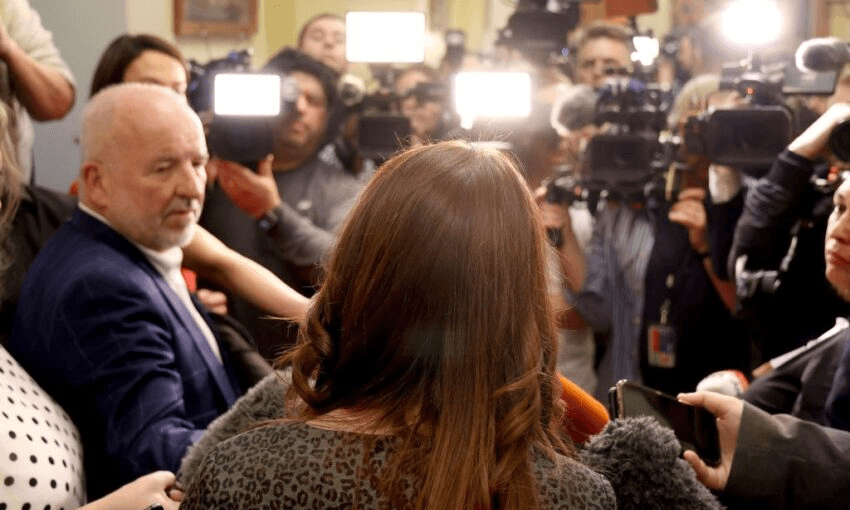 Jacinda Ardern takes questions from Barry Soper and a bunch of other journalists at Parliament Photo by MARTY MELVILLE/AFP via Getty Images 
