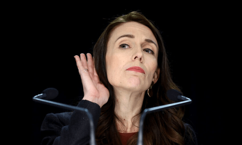 Jacinda Ardern seeks clarity from someone in the press pack during the cabinet announcement at parliament. (Photo by Hagen Hopkins/Getty Images) 
