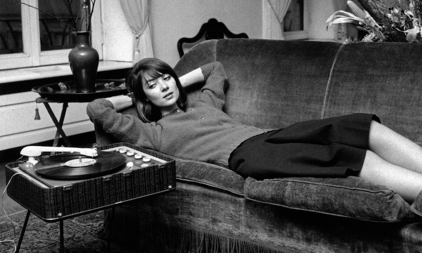 A young woman listening to the record player