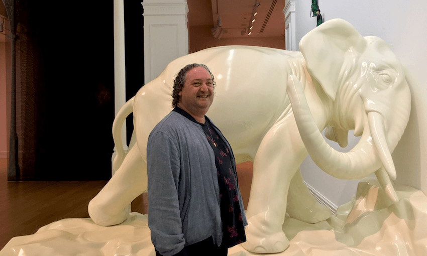 Auckland Art Gallery curator Māori art, Nigel Borell, in front of Michael Parakowhai’s ‘Te ao hurihuri’. (Photo: Leonie Hayden) 
