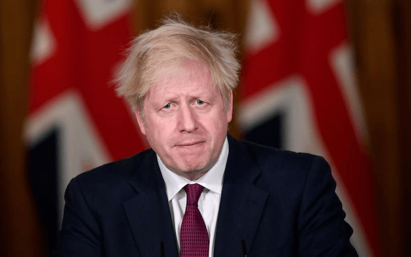 Britain’s PM Boris Johnson holds a virtual press conference at 10 Downing Street on December 19 to announce the move to Tier 4 (Photo: Toby Melville/Pool/AFP via Getty Images) 
