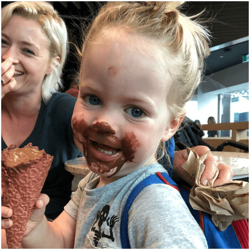 Little boy eating ice cream, Mum laughing