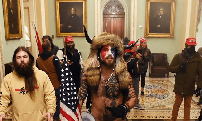 Supporters of President Trump, including Jake Angeli (C), a QAnon supporter known for his painted face and horned hat, enter the US Capitol on January 6, 2021, in Washington, DC. (Photo: SAUL LOEB/AFP via Getty Images) 

