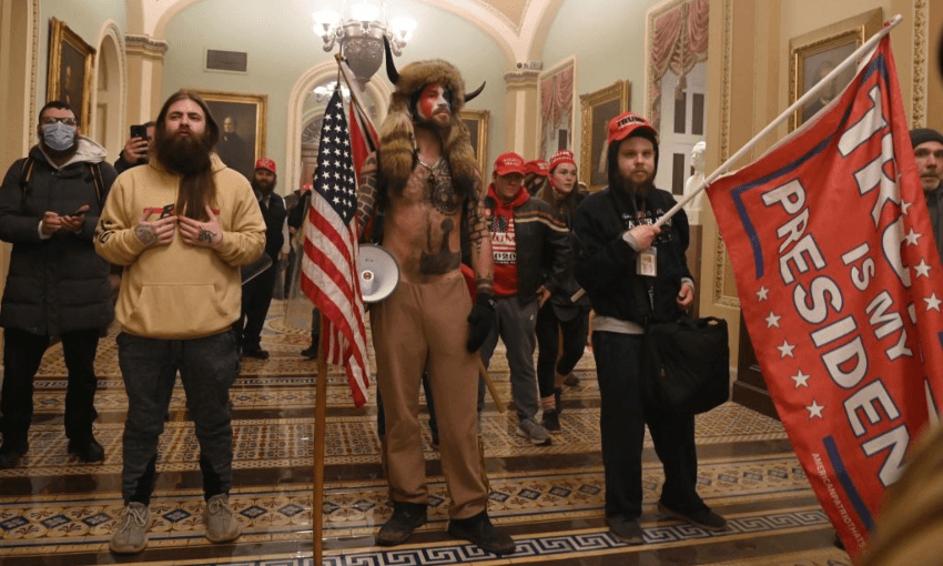 The QAnon ‘shaman’ at the US Capitol. (Photo by SAUL LOEB/AFP via Getty Images) 

