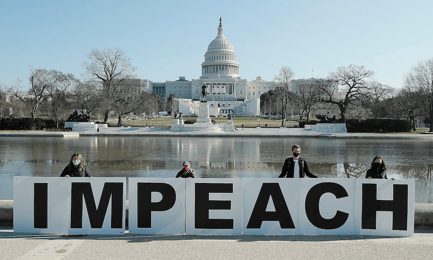 People gather at the base of the US Capitol with large IMPEACH and REMOVE letters on January 12 (Photo: Paul Morigi/Getty Images for MoveOn) 
