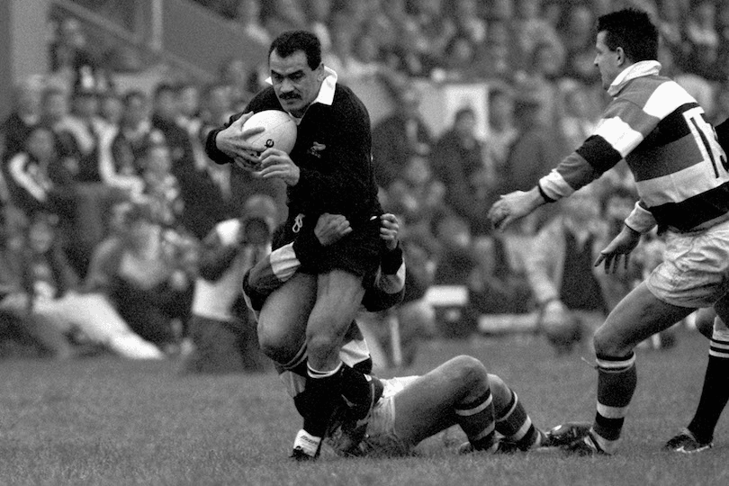 Black and white photo of former All Black Smokin Joe Stanley being tackled.
