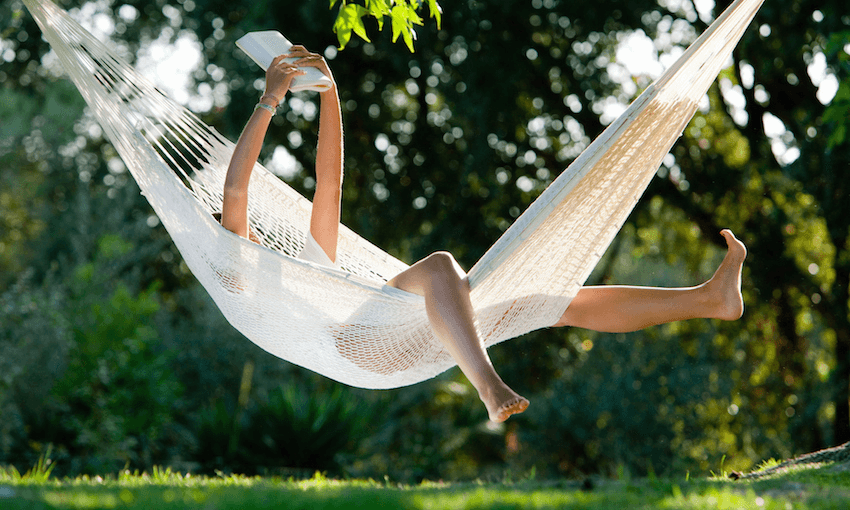 A person reading in a hammock, limbs akimbo