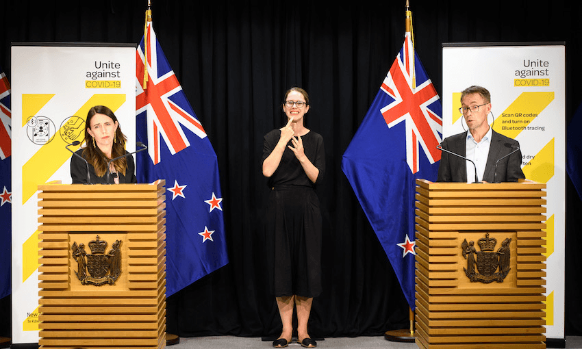 Jacinda Ardern and Ashley Bloomfield announcing the new Covid-19 restrictions at the Beehive on the evening of February 14 (Photo: Mark Tantrum/Getty Images) 
