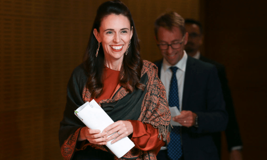 Jacinda Ardern and Ashley Bloomfield arrive at the Beehive press conference to announce a decision on alert levels, February 2021 (Photo by Hagen Hopkins/Getty Images) 
