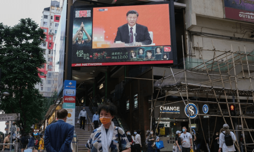 A speech from President Xi being broadcast on a giant screen above a Hong Kong street (Getty Images)