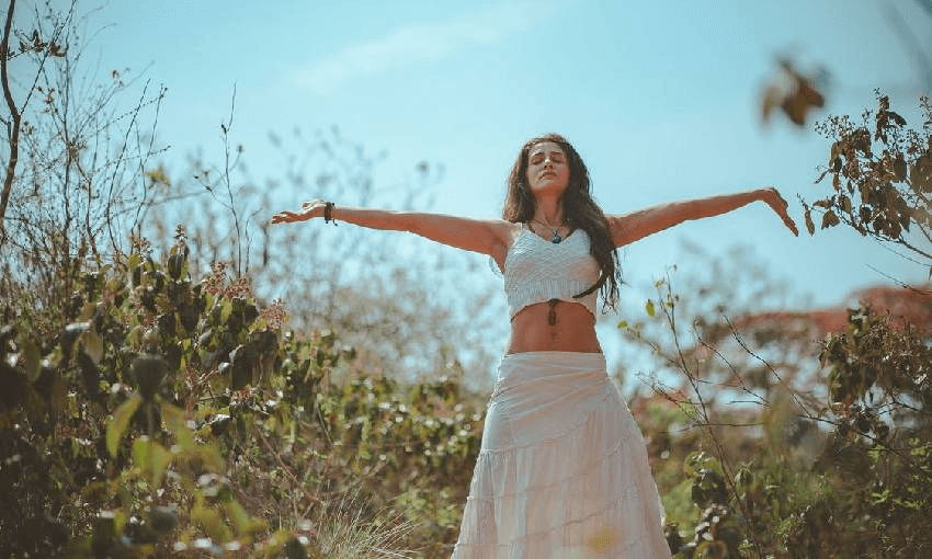 a woman meditating in a field