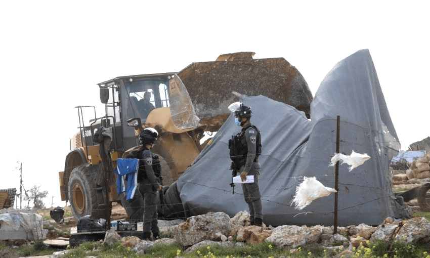 Israeli forces demolish allegedly ‘unauthorised’ houses belonging to three different Palestinian families in Hebron, West Bank on March 2, 2021. Israeli forces left 12 Palestinians homeless. (Photo: Mamoun Wazwaz/Anadolu Agency via Getty Images) 
