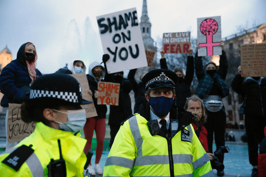 On March 15, police officers stand in front of people protesting police’s actions at the vigil the night before in Clapham Common (Photo: Hollie Adams/Getty Images) 
