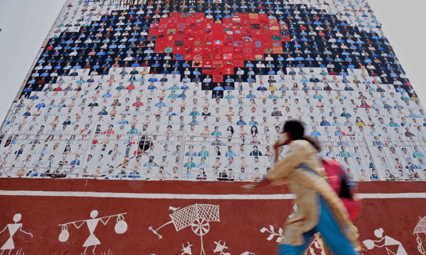 A mural of tribute to Covid-19 frontline workers in Mumbai.  Photo by SUJIT JAISWAL/AFP via Getty Images 
