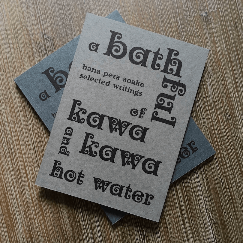 Two books, one grey and one a muted blue, both A Bathful of Kawakawa and Hot Water
