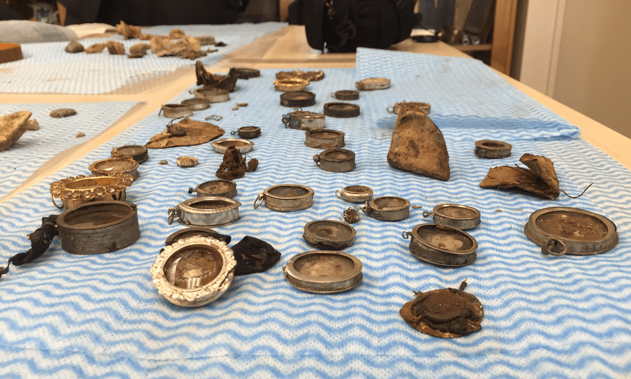 Relics uncovered from Christchurch’s Catholic cathedral (on a blue Chux cloth). (Photo: Oliver Lewis) 
