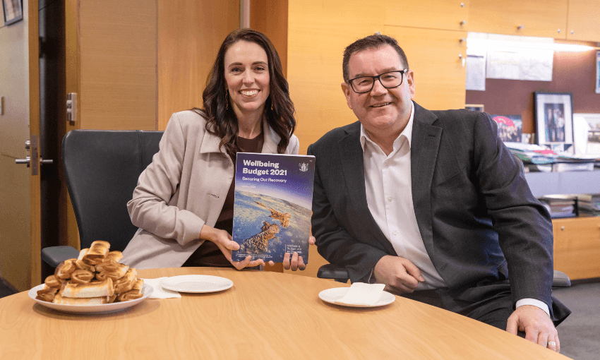 Jacinda Ardern and Grant Robertson celebrate the arrival of a big plate of cheese rolls. Photo: Supplied 

