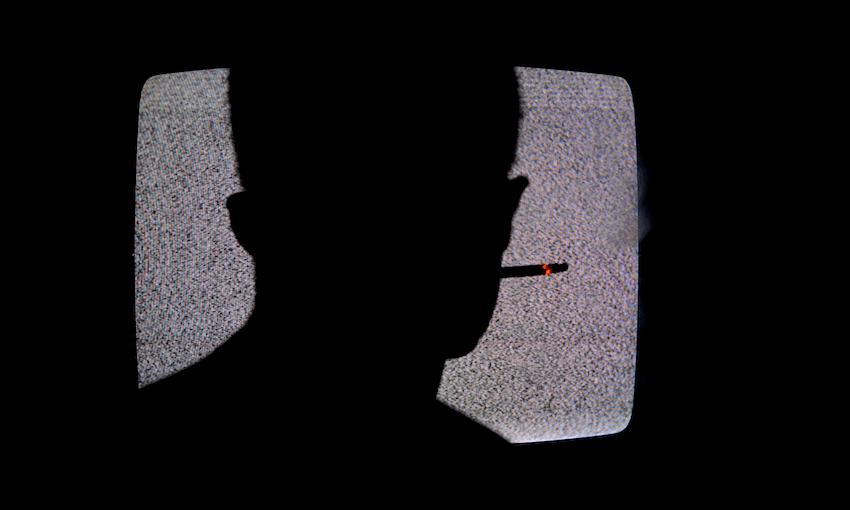 Silhouette Of Man Smoking Cigarette And Watching Television In Dark