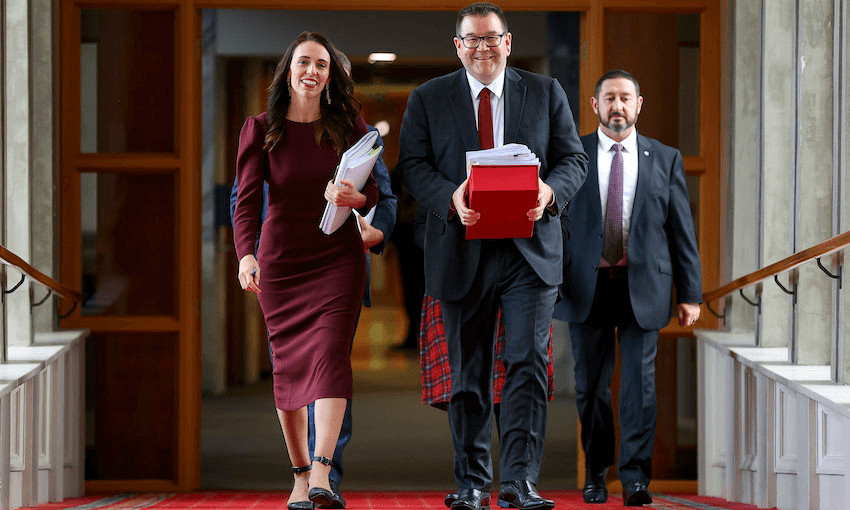 Prime minister Jacinda Ardern and finance minister Grant Robertson make their way to the house on budget day on May 20, 2021 (Photo: Hagen Hopkins/Getty Images) 
