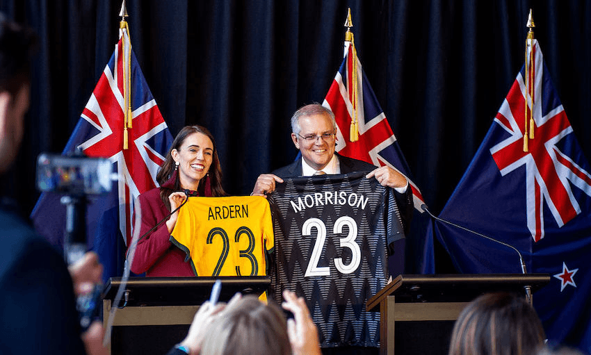 New Zealand Prime Minister Jacinda Ardern and Australian Prime Minister Scott Morrison swap football jerseys during a joint press conference on May 31, 2021 in Queenstown. (Photo: Joe Allison/Getty Images) 
