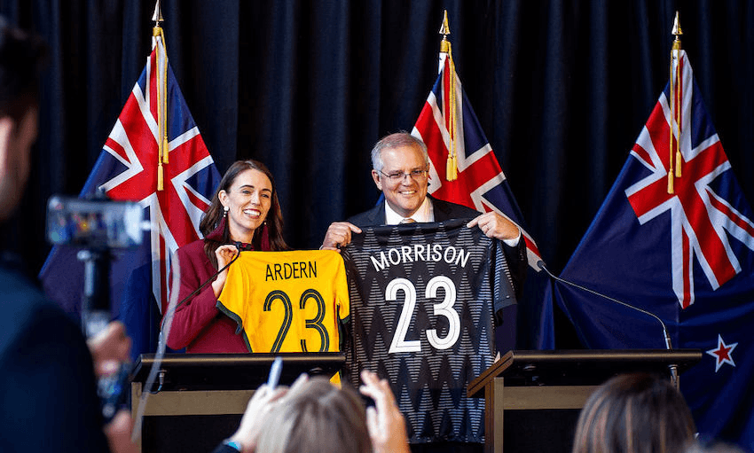 New Zealand Prime Minister Jacinda Ardern and Australian Prime Minister Scott Morrison swap football jerseys during a joint press conference on May 31, 2021 in Queenstown. (Photo: Joe Allison/Getty Images)