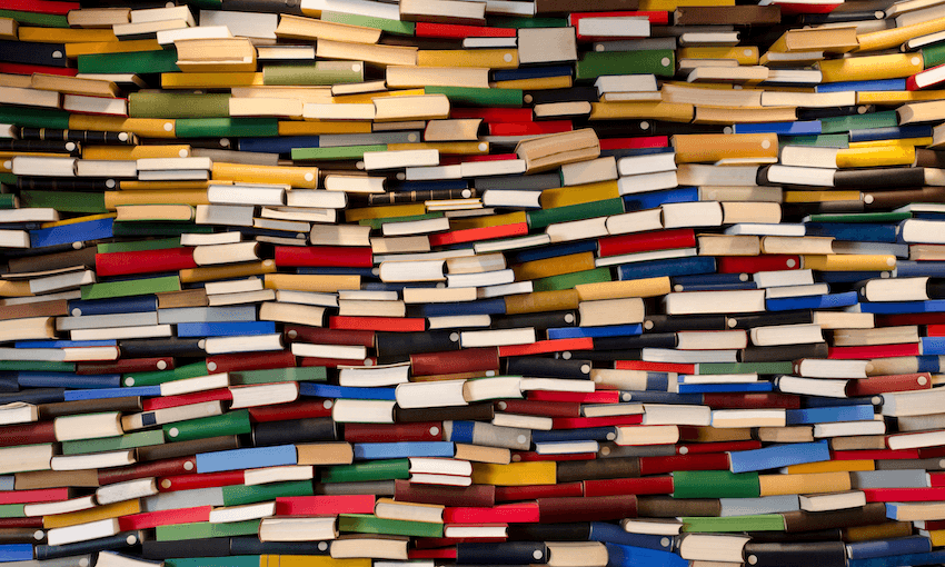 Hundreds of books piled up in a wall