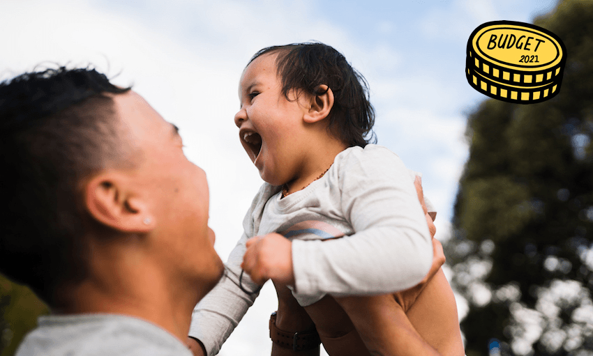 A happy Māori man lifts up his laughing baby.