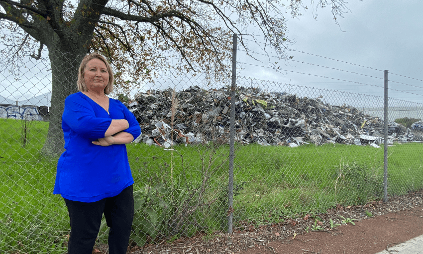 Auckland councillor Angela Dalton outside the massive pile of scrap metal in Takanini. (Photo: Justin Latif) 
