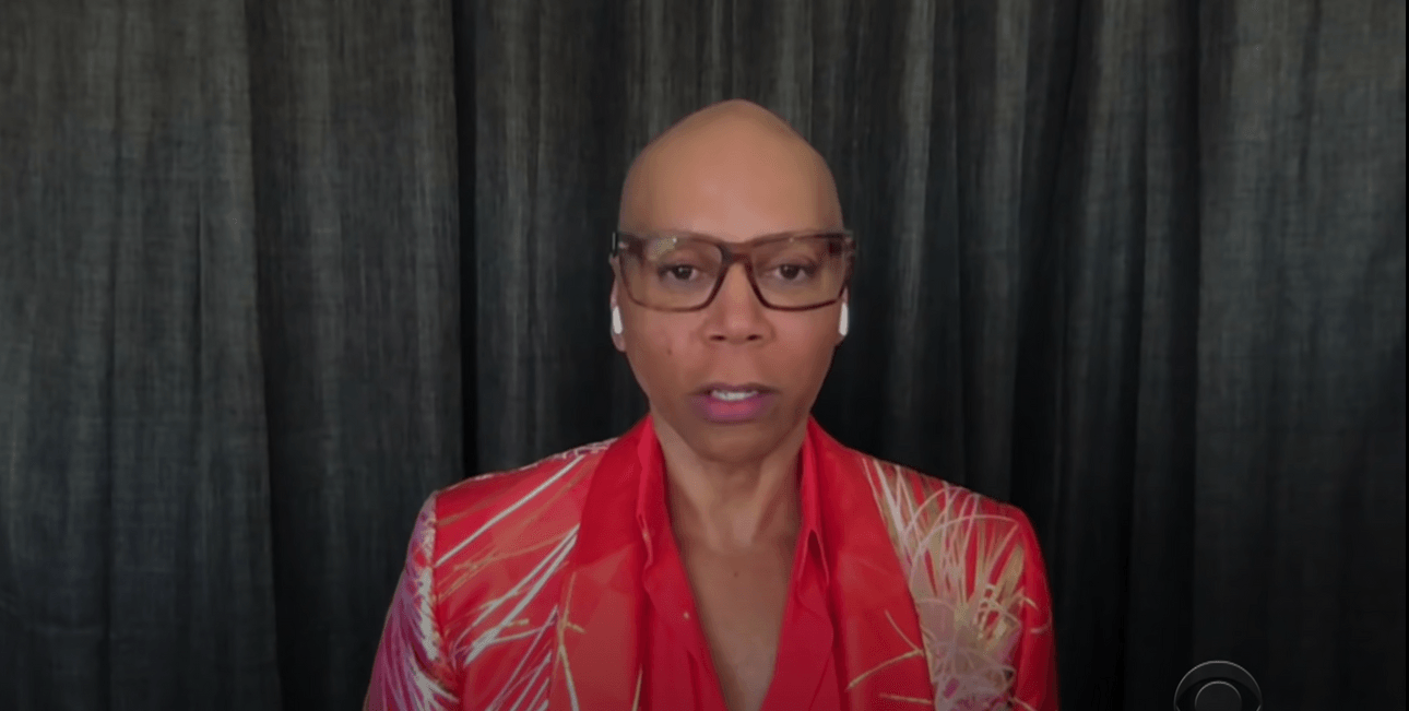 RuPaul in front of curtains