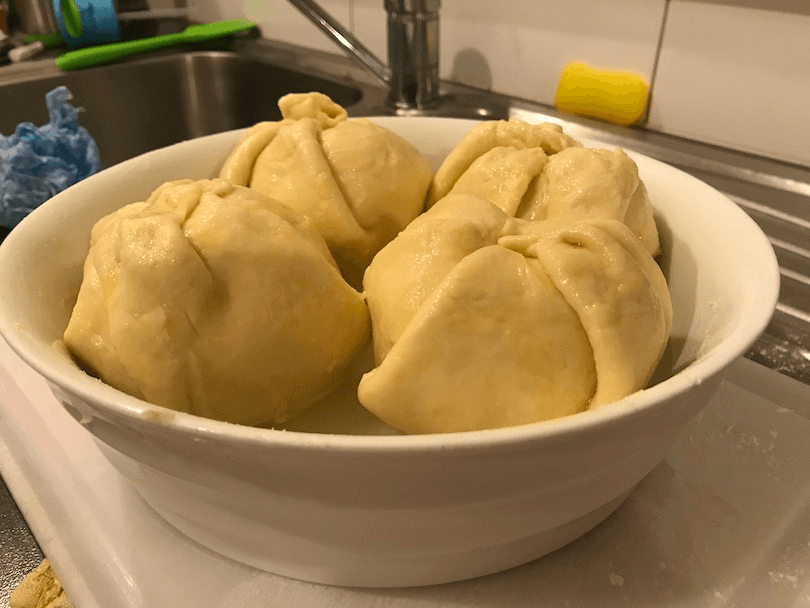 A dish of four huge spheres - apples wrapped in scone dough