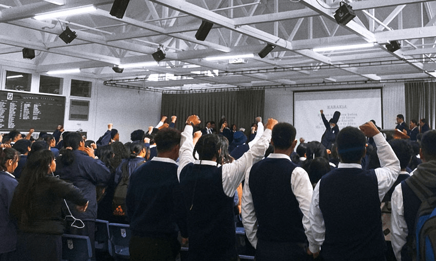 Māngere College students raise their fists with Tigilau Ness (Photo: Justin Latif) 
