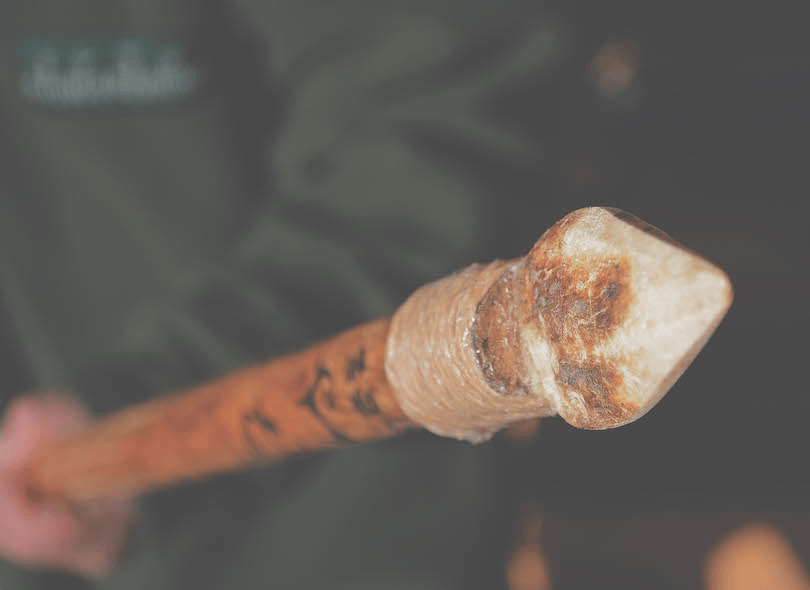 The spear, blunt tip pointed at the camera