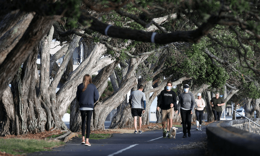 People exercise along Tamaki Drive on Auckland’s waterfront on August 24, 2021. (Photo: Fiona Goodall/Getty Images) 
