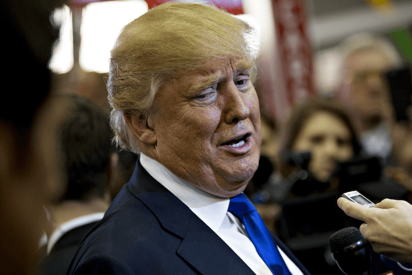 Close up of Donald Trump talking and clearly loving himself talking, into a dictaphone held by a reporter