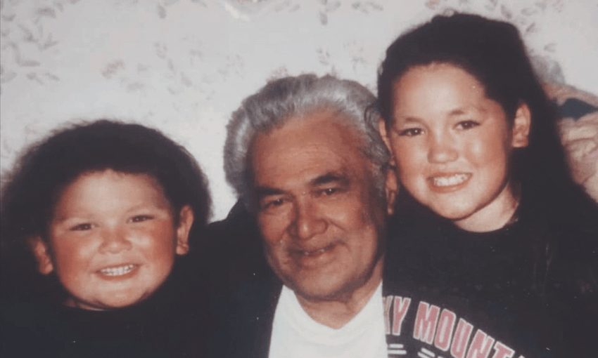 A family photo showing a grandfather flanked by two beaming kids, a boy and a girl.