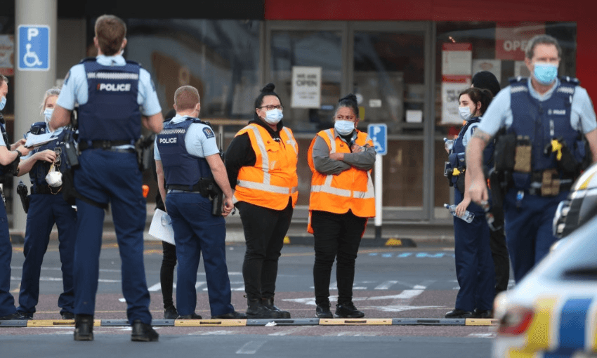 Countdown LynnMall staff comfort each other after a violent extremist stabbed six people before being shot by police (Photo: Fiona Goodall/Getty Images) 
