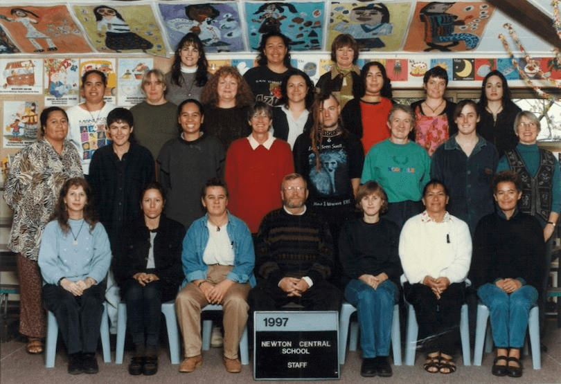 Classic class photo setup but with teachers, it's 1997 so the clothes are rad; an array of interesting characters