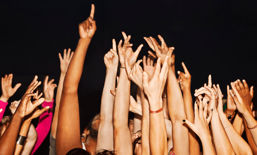 Large crowd with hands up