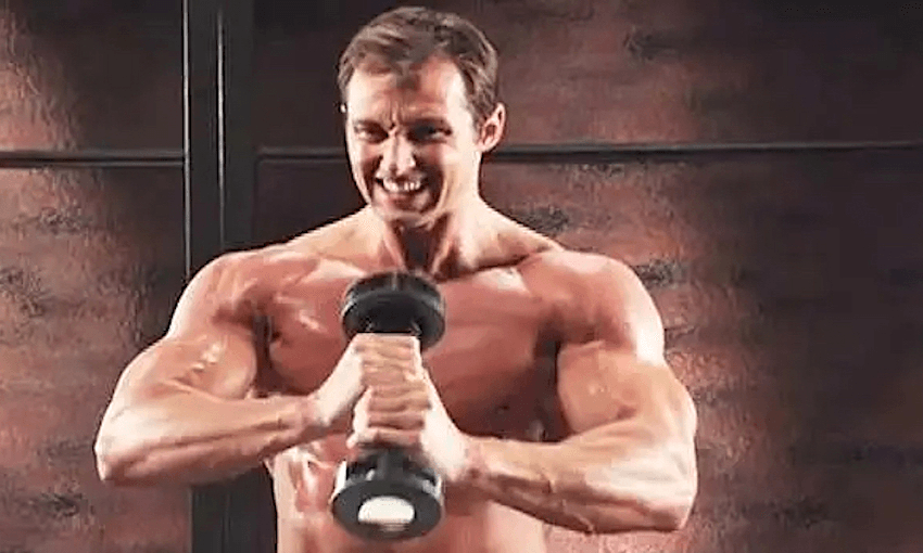Muscled man holding a Shake Weight excercise device