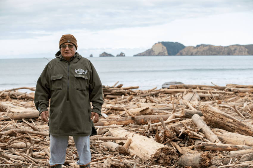 Zak Horomia in 2018 standing on the slash washed down from the hills into Tolaga Bay