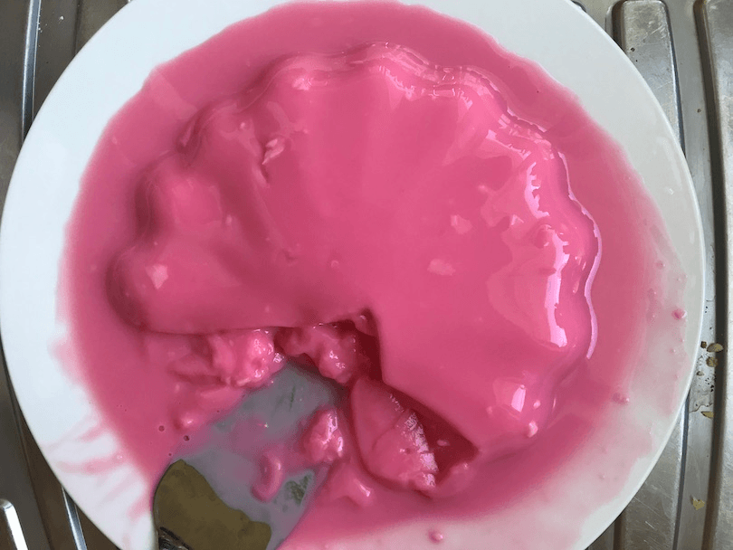 Aerial view of a glossy pink pudding.