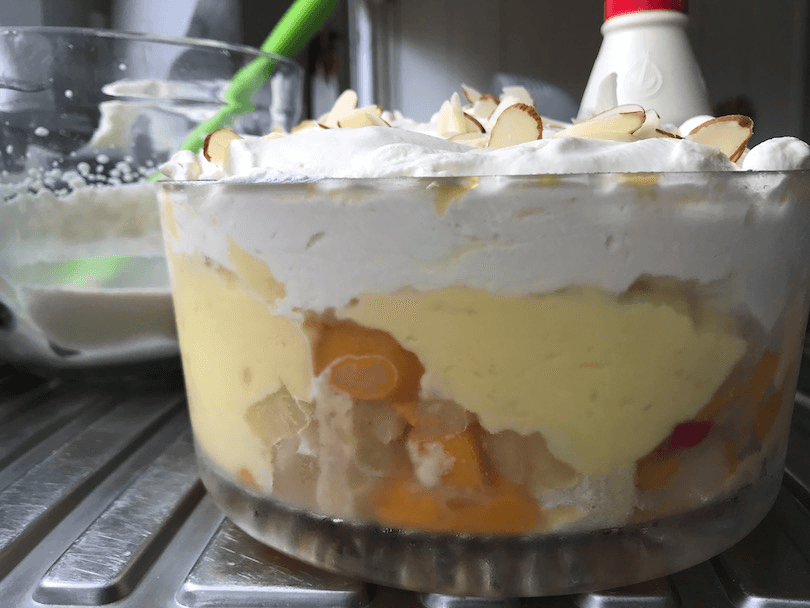 Side view of a magnificently big, if dull-looking trifle. Lots of custard and cream, no pretty strawberries or anything. 