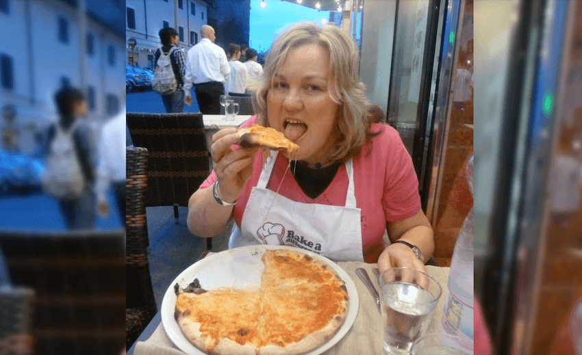 Julie Woods eating cheesy Italian pizza