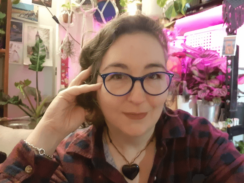 Selfie of a young woman in a glorious room full of plants and colour.